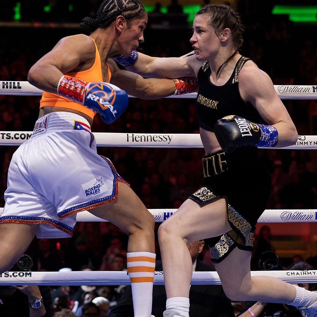 alt="Taylor vs Serrano 1, women’s boxing history, Katie Taylor with Leone Sport gloves"