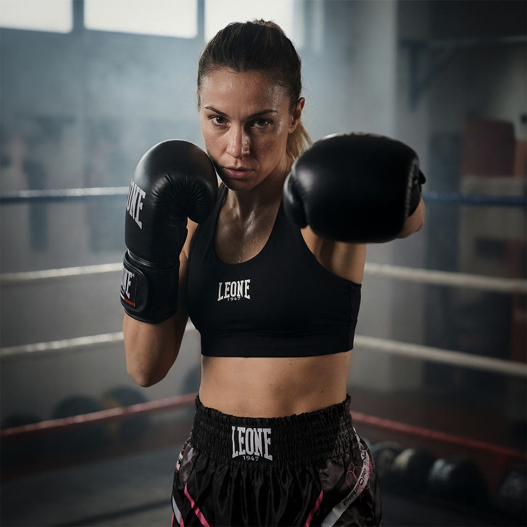 Atleta kick boxe femminile con attrezzatura e abbigliamento tecnico Leone 1947